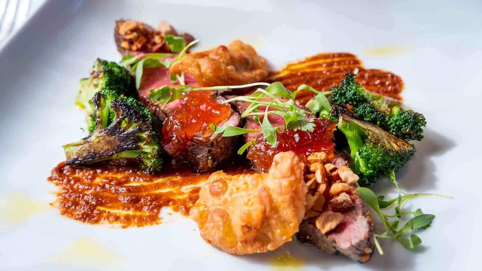 Five Dot Ranch Flat Iron Steak - Soffritto Empanada, Onion Citrus Marmalade, Charred Broccoli, Ancho Adobo, Almonds. At Gatehouse Restaurant at the CIA at Greystone.